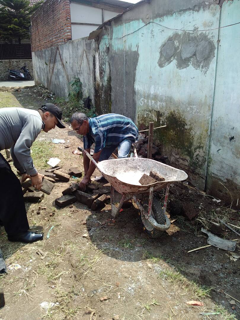 Bhabinkamtibmas Polsek Batu Polres Batu kelurahan Temas membantu  perbaikan jalan yang rusak