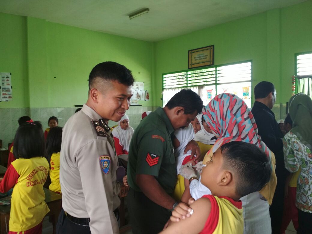 Bhabin Desa Pendem Polsek Junrejo Polres Batu Sambang  Sekolah Dalam Pelaksanaan Imunisasi Difteri.